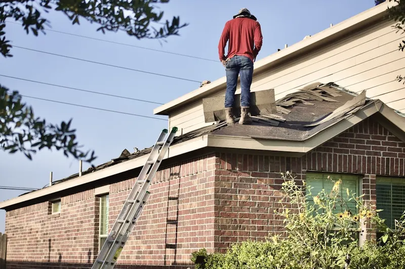 Professional roofer working on a residential roof in Wethersfield